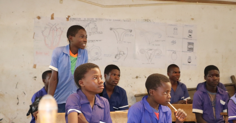 A boy answering a question from the teacher